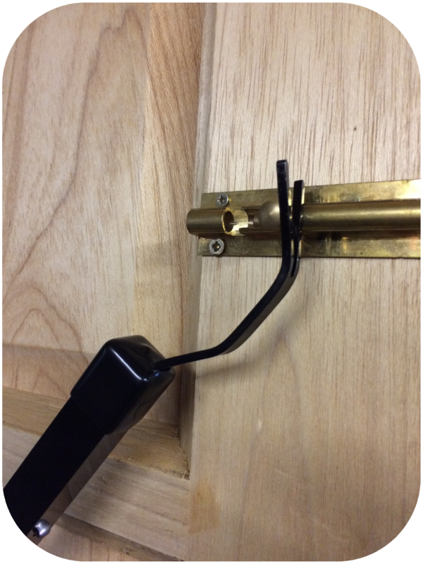The Claw Locksmiths Letterbox Tool Attachment on a door bolt from Outside-In Lock Tools