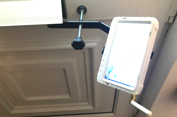 Inside of a door with Monitor bracket through the letterbox and white monitor attached