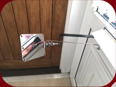 Stainless-steel Locksmiths Mirror passed through a letterbox and shown on the inside of a door