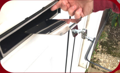 Locksmiths Letterbox Tool Stainless-Steel Mirror being passed through a letterbox in a white door