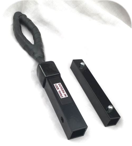 Locksmiths black metal and rubber tool with a black metal connector laid out on a white background