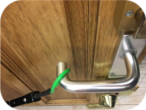 Lime green rubber loop attached to a door handle on the inside of the door